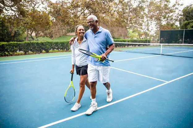 a senior couple playing tennis