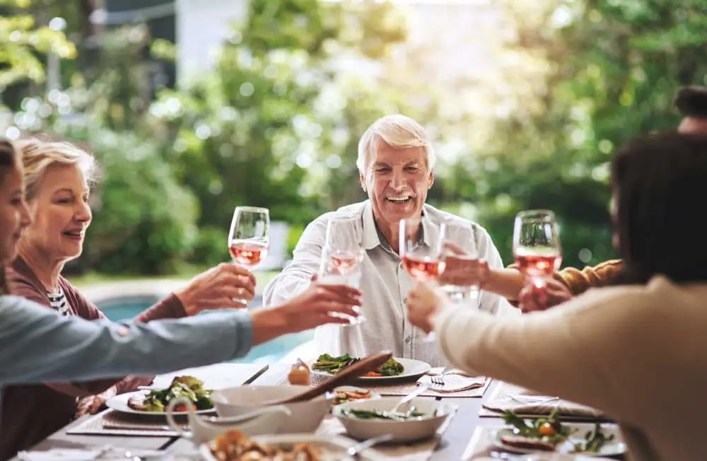 a group of seniors toasting during diner