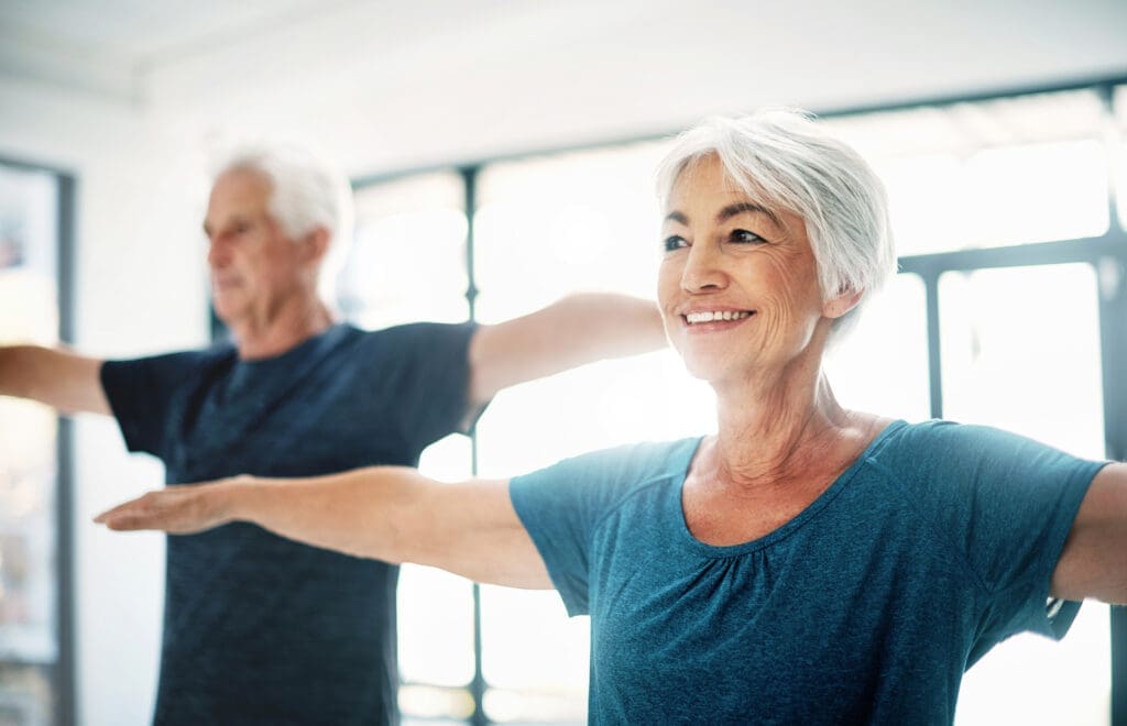 Senior woman and man in exercise class